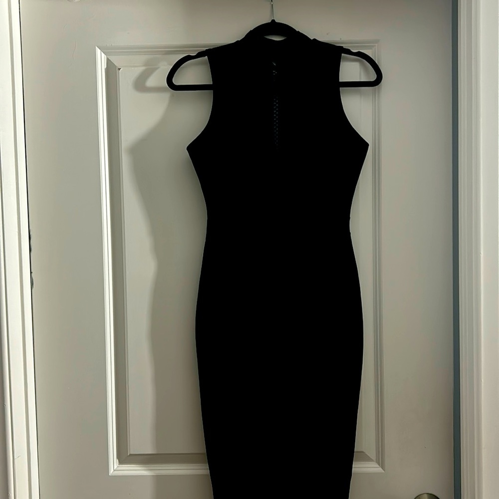 Black polyester spandex mix cocktail dress, machine washable.